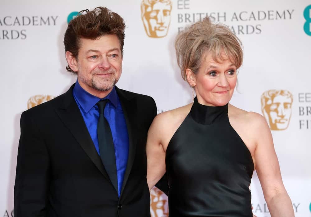 Andy and Lorraine posing in front of the BAFTAs logo backdrop