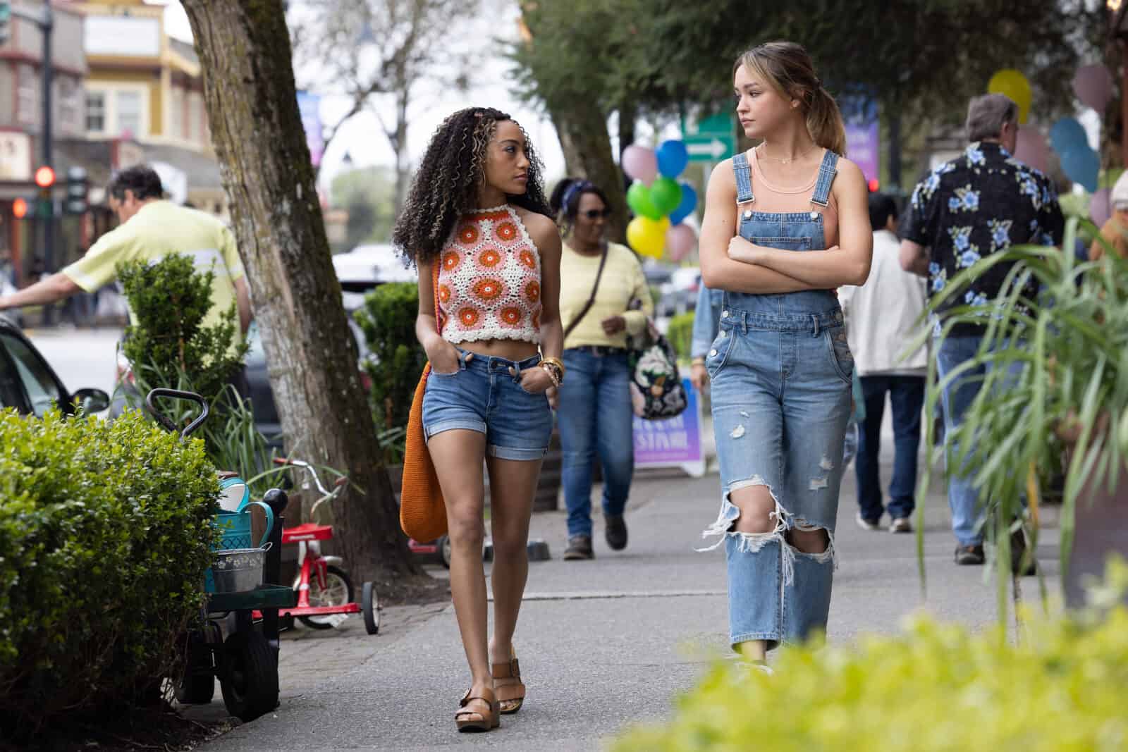 Two teenage girls walk next to each other outdoors in this photo by Entertainment One