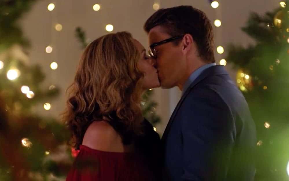 A woman and man kiss in a Christmas setting in this image from Active Entertainment