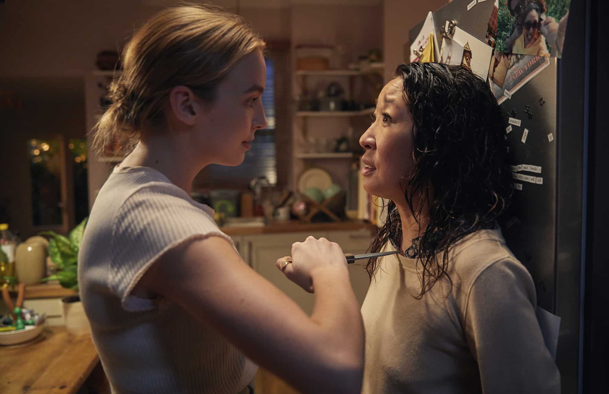 Villanelle holding a knife to Eve’s throat in a kitchen