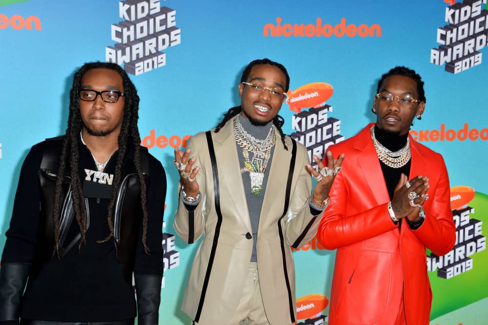 Migos looking satisfied on the orange carpet