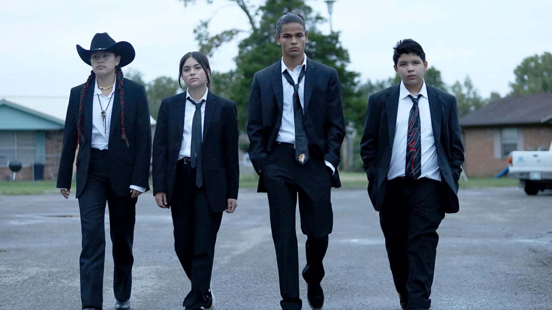 Paulina Alexis, Devery Jacobs, D'Pharaoh Woon-A-Tai, and Lane Factor dressed in black suits and ties in this image from FXP