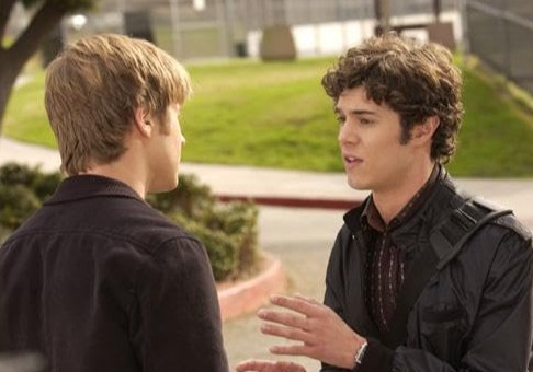 Two men stand in the street in this image from Warner Bros. Studios