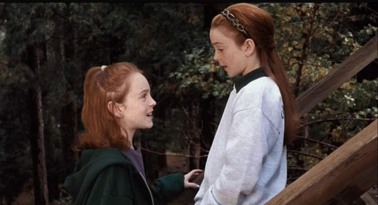 Hallie smiling at Annie on a staircase at summer camp