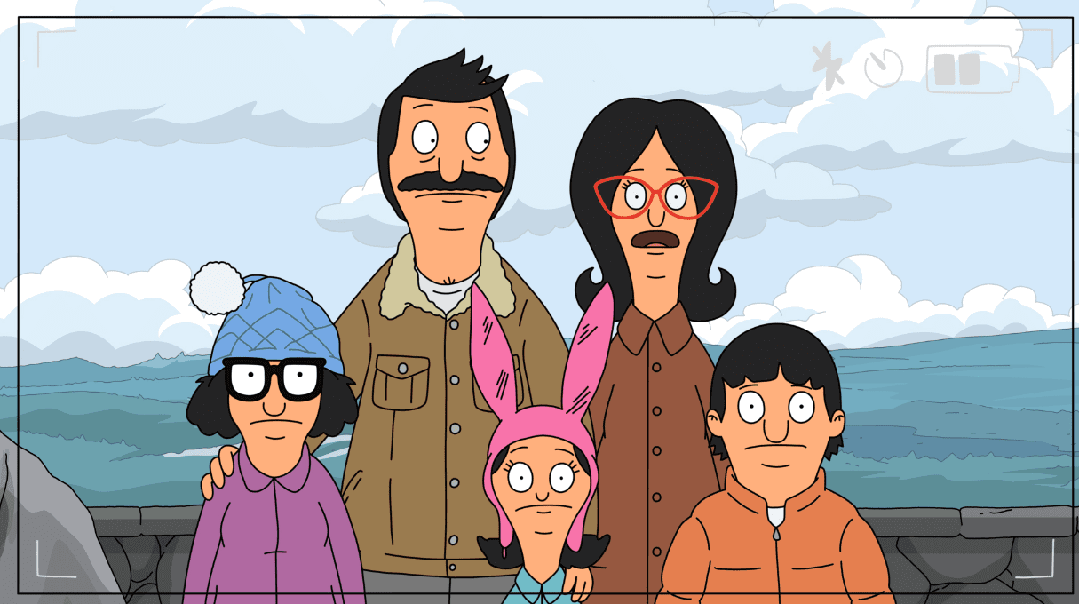 The Belcher family posing for a photo opportunity in front of a mountain outlook