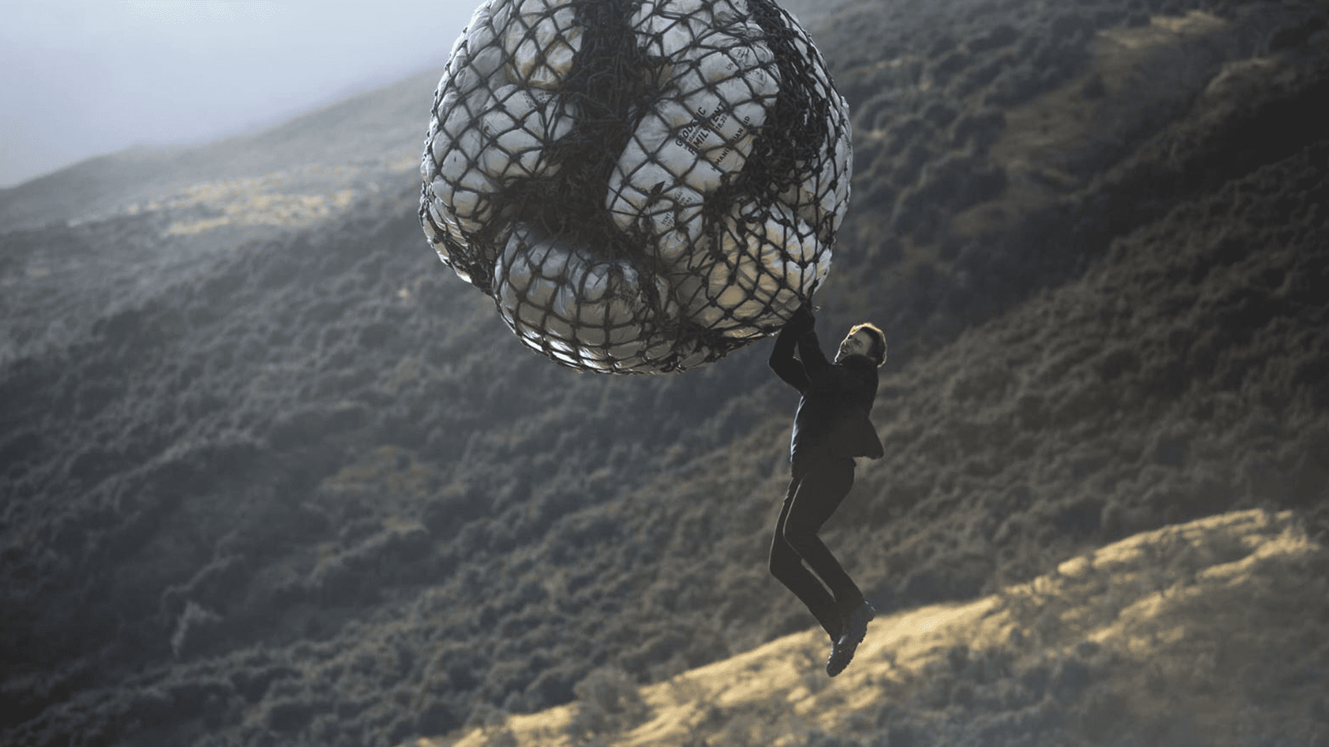 Tom Cruise hangs in midair from a net in this image from Paramount Pictures