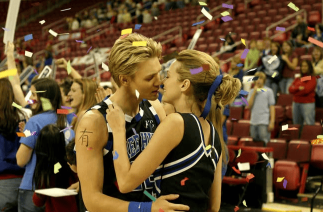 Two teenagers go in for a kiss after a basketball game from the TV series One Tree Hill in this image from Tollin/Robbins Productions/Warner Bros. Television