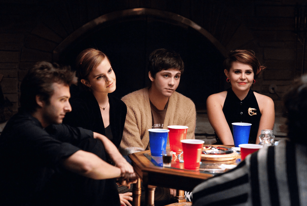 The cast sitting on the floor during a game